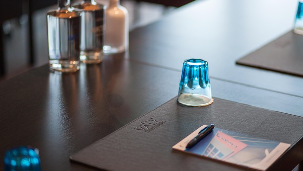 De Gouden Leeuw zaal met notitieboekjes en water voor tijdens vergaderingen, meetings, bijeenkomsten en besprekingen